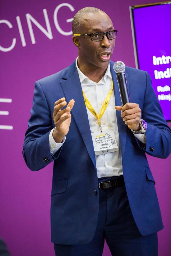Fredi Nonyelu delivering a keynote presentation